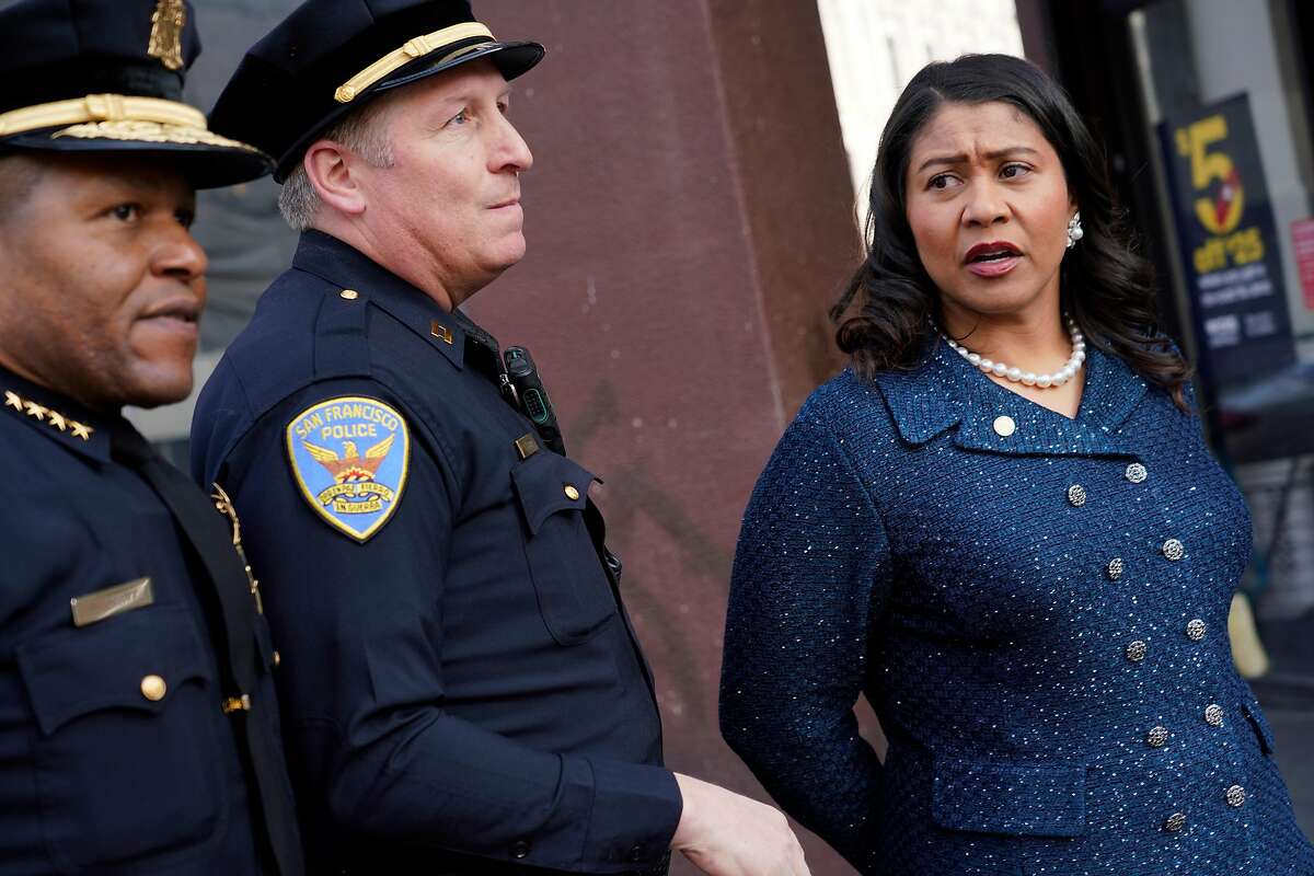 Mayor London Breed (right), San Francisco Police Chief Bill Scott (left) and Captain Carl Fabbri (center) look down Market Street while out walking with a Healthy Streets Operation Center team in a new program called �Healthy Streets Intervention" on Wednesday, November 14, 2018 in San Francisco, Calif.