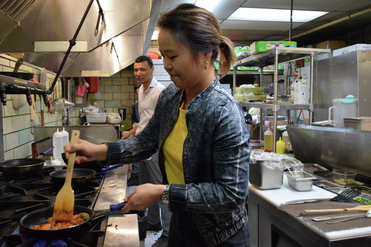 Jinah Kim, owner of Sunhee's Farm Kitchen and Restaurant in Troy works in the kitchen with Hamid Razai, 38, from Afghanistan, on Dec. 13, 2018 in Troy, N.Y. Most of her kitchen staff are refugees or immigrants.