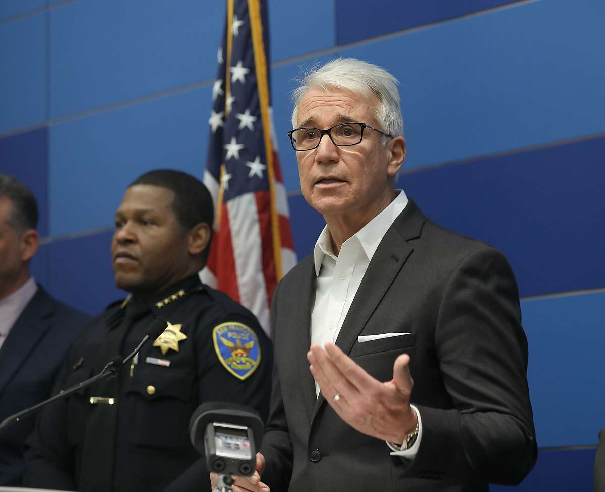 Law enforcement officials including district attorney George Gascon (right) and SF police chief Will Scott (left) announce the dismantling of a major fencing operation dubbed "operation wrecking ball" in which 40 fugitives were identified and 12 people were arrestedon Thursday, Dec. 20, 2018, in San Francisco, Calif.