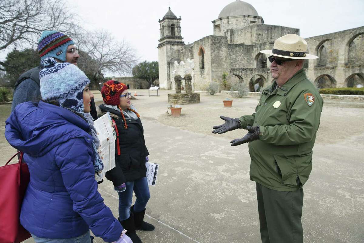 Visitors from Mexico City listen to National Park Service Park Ranger Tom Castanos on the grounds of Mission San José on Jan. 17. From left are Mariel Vazquez, Rodrigo Diaz and Mirely Vazquez.