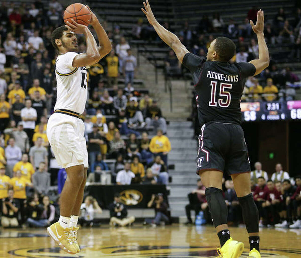 University of Missouri sophomore Mark Smith, left, puts up a shot during a game against Temple on Nov. 27 at Mizzou Arena.