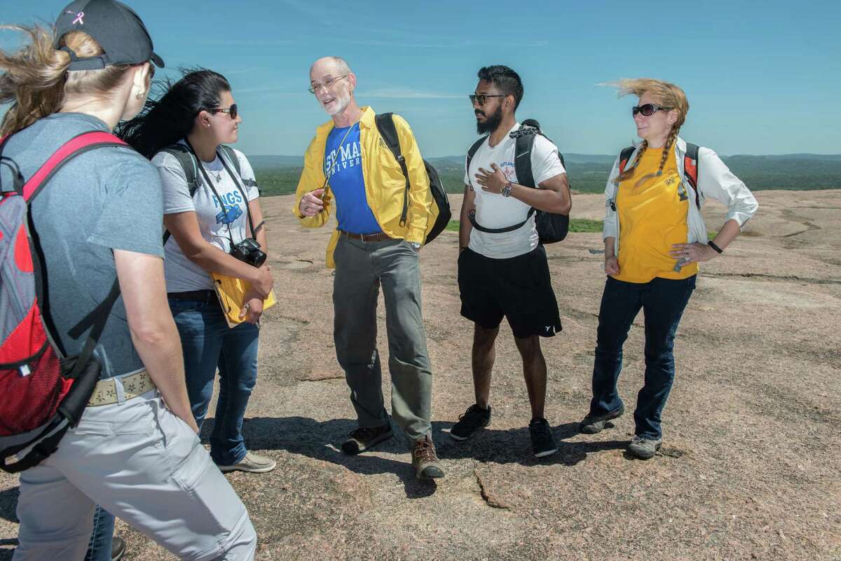 David Turner, Associate Professor of Environmental Science at St. Mary’s University, center, leads geology students on a hands-on learning experience to Enchanted Rock State Natural Area.