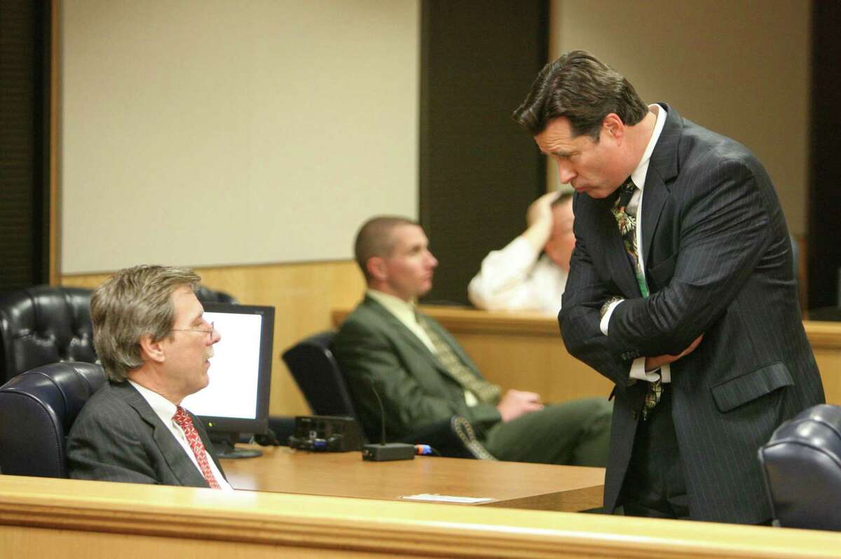 Fort Bend County District Attorney John Healey, right, speaks with Randy McDonald, defense attorney for Bart Whitaker, as they wait for the jury to return with a sentence in 2007. Whitaker was convicted of the 2003 murder-for-hire killing of his mother and brother and was scheduled to be executed this past February, but had his sentence commuted to life in prison by Gov. Greg Abbott.