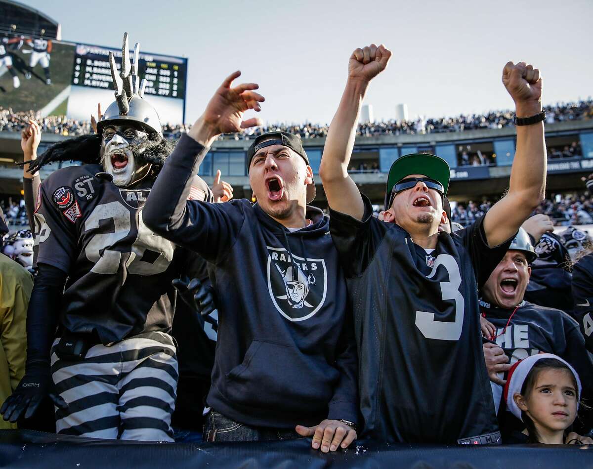 A pregnant Oakland Raiders fan watches the game against the Kansas