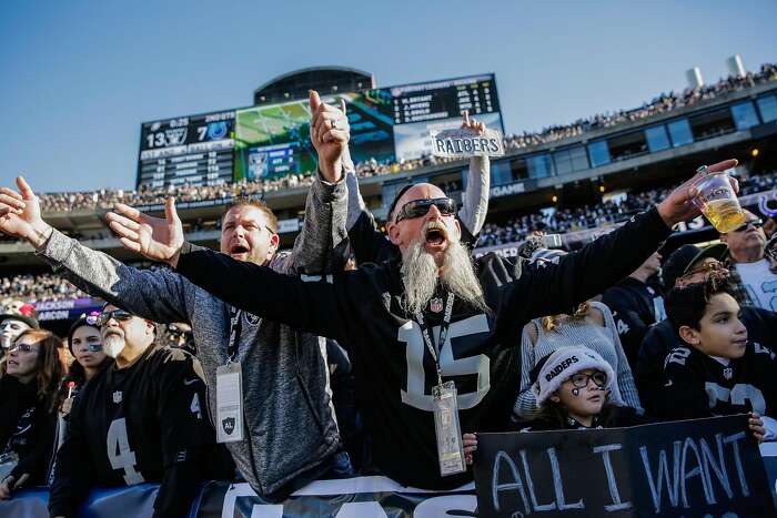 Oakland Raiders fans tailgate in rain at their team's likely last