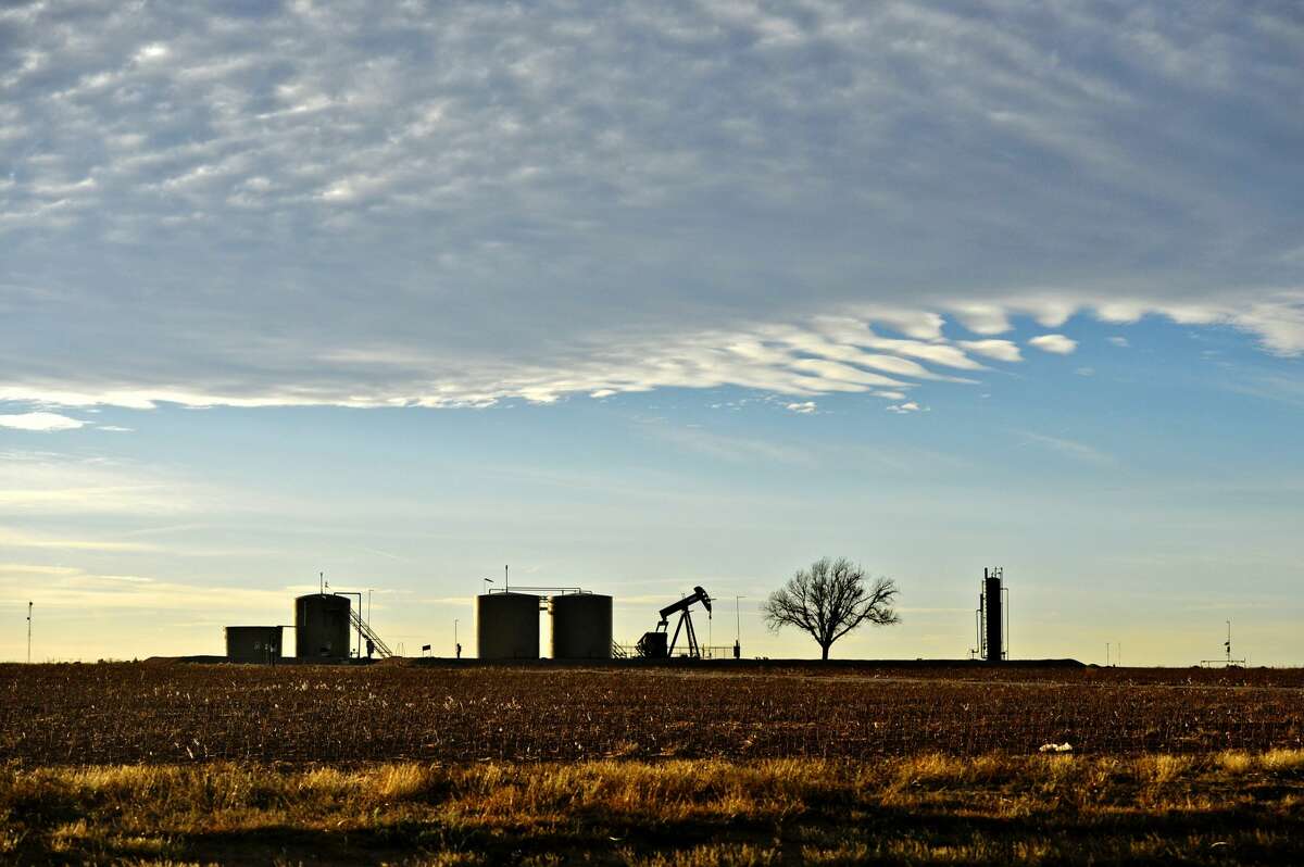 Pumpjack and tank battery operating in Greenwood, Midland County, Texas, Dec. 21, 2018. KEEP GOING to see photos of oil production in the Permian Basin.