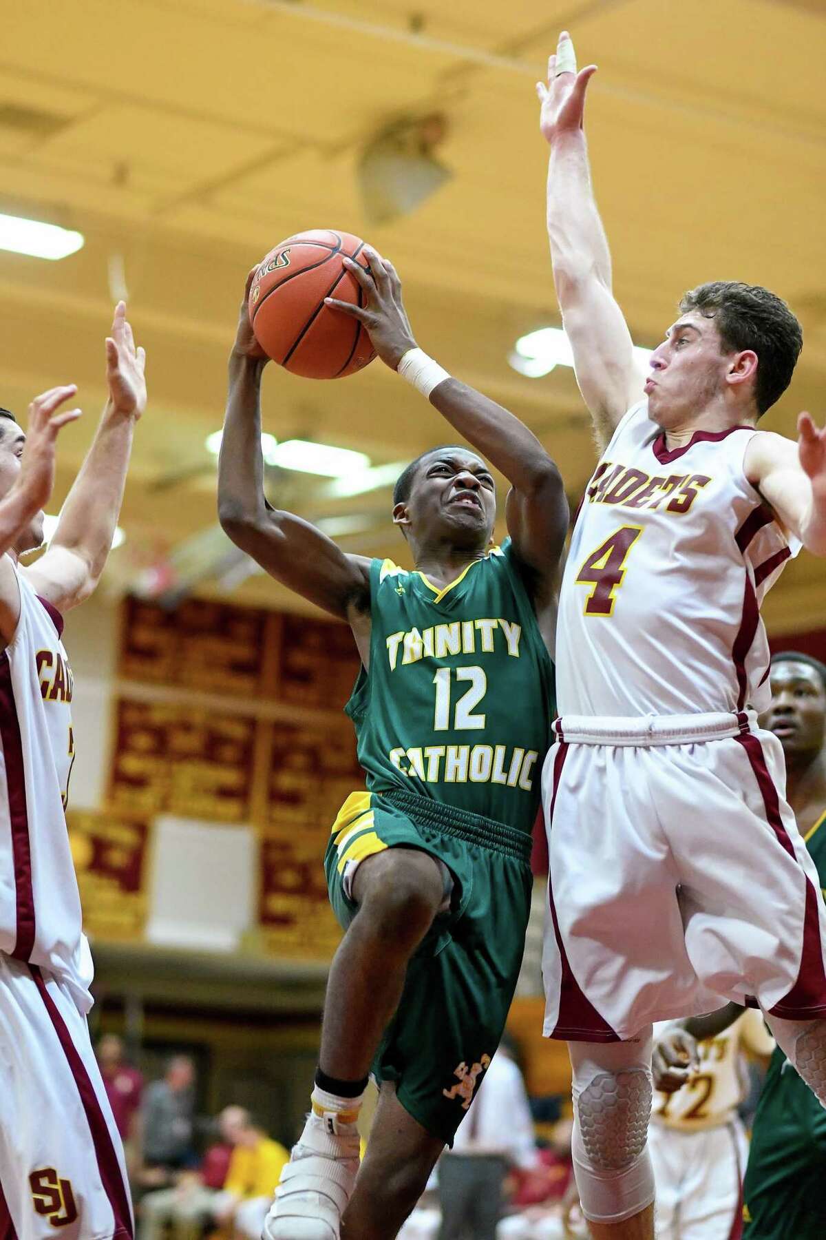 Trinity Catholic’s Akim Joseph brings the ball to the basket against St. Joseph on Friday in Trumbull.