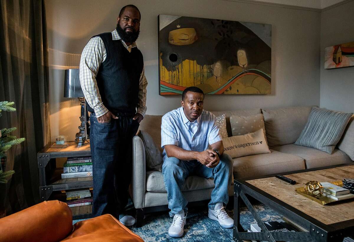 Shadeed Wallace-Stepter (right) and Earlonne Woods pose for a portrait in the living room of Re:Store Justice in Oakland, Calif. Thursday, Dec. 20, 2018.