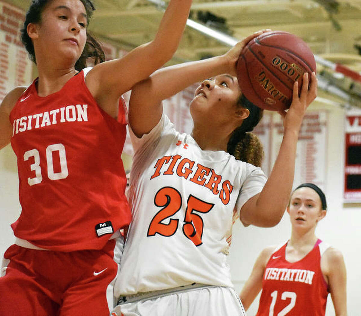Edwardsville forward Sydney Harris, right, is fouled as she goes up for a shot in the first half of Saturday’s game in the Visitation Christmas Tournament.