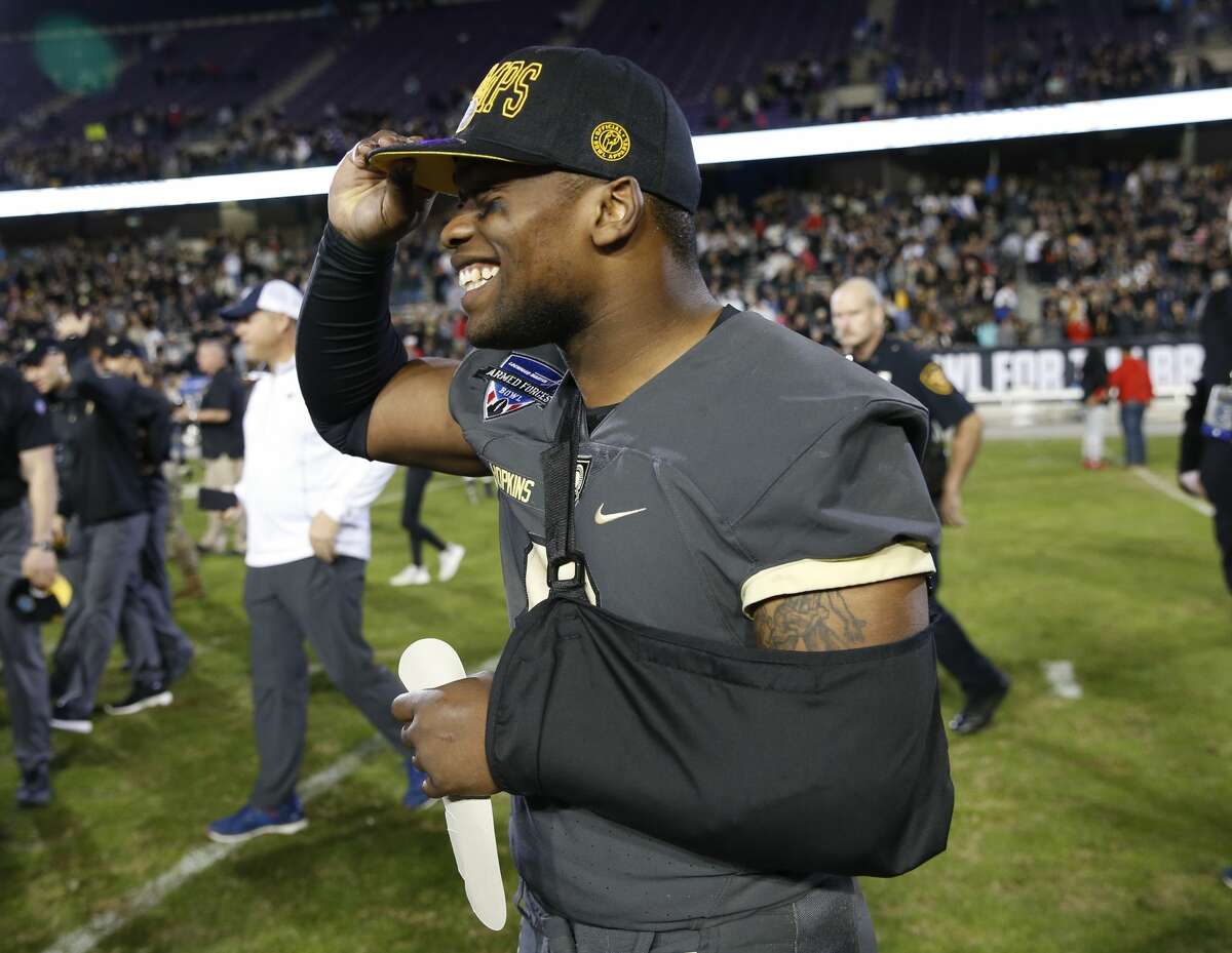 Army quarterback Kelvin Hopkins Jr. smiles as he puts on his championship cap following his team's win over Houston in the Armed Forces Bowl NCAA college football game Saturday, Dec. 22, 2018, in Fort Worth, Texas. Army won 70-14. (AP Photo/Jim Cowsert)