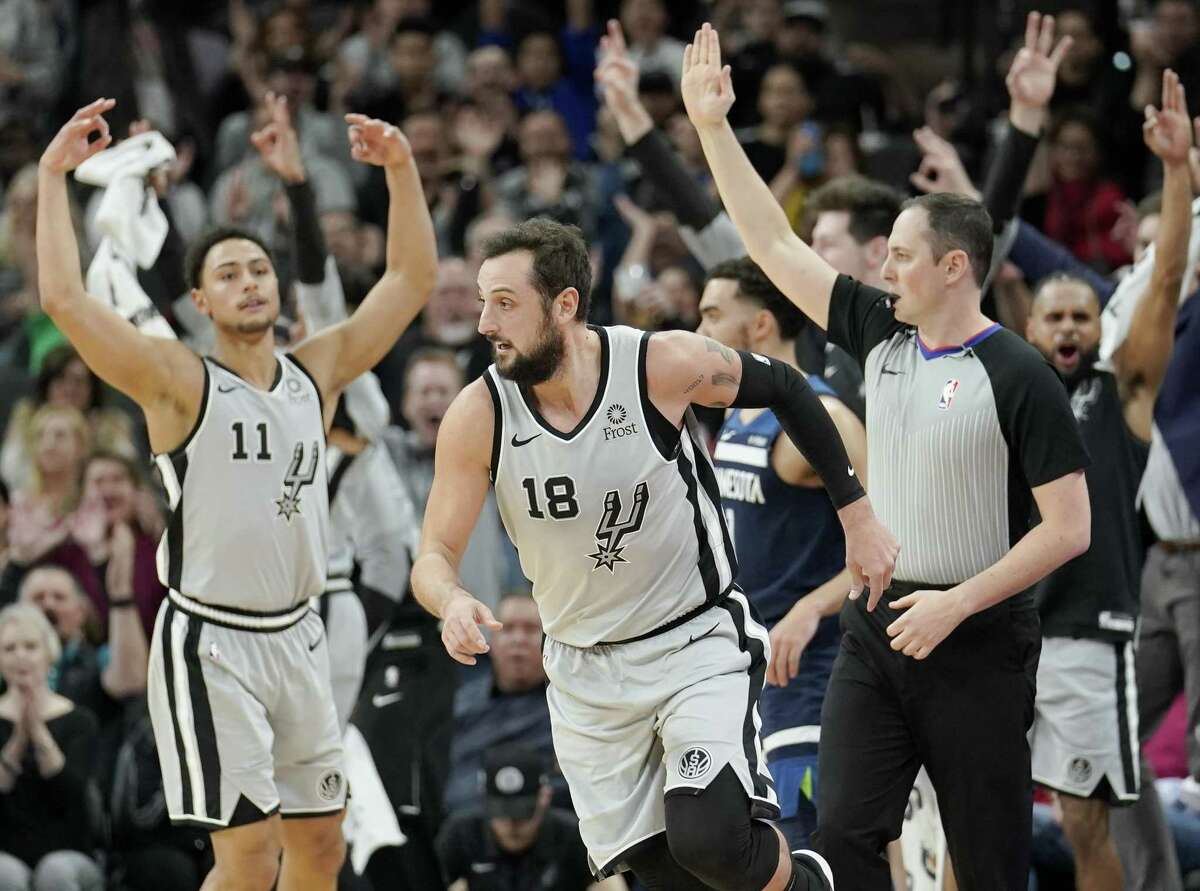 San Antonio Spurs' Marco Belinelli (18) runs upcourt after scoring a three-point basket as the team's bench and fans celebrate during the first half of an NBA basketball game against the Minnesota Timberwolves, Friday, Dec. 21, 2018, in San Antonio. (AP Photo/Darren Abate)