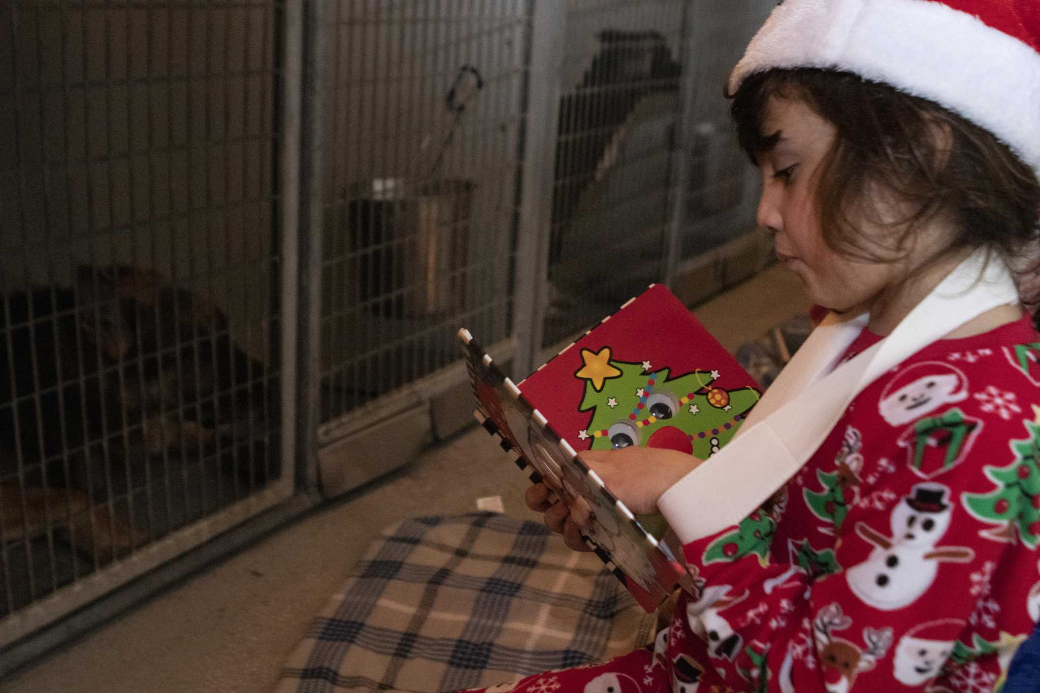 Children read to Montgomery County Animal Shelter dogs for Christmas