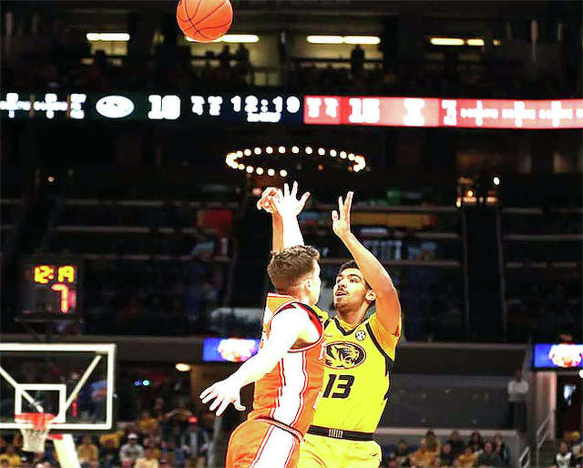 University of Missouri sophomore Mark Smith, right, puts up a 3-point shot over Illinois defender Tyler Underwood during Saturday’s Braggin’ Rights game at Enterprise Center in St. Louis.
