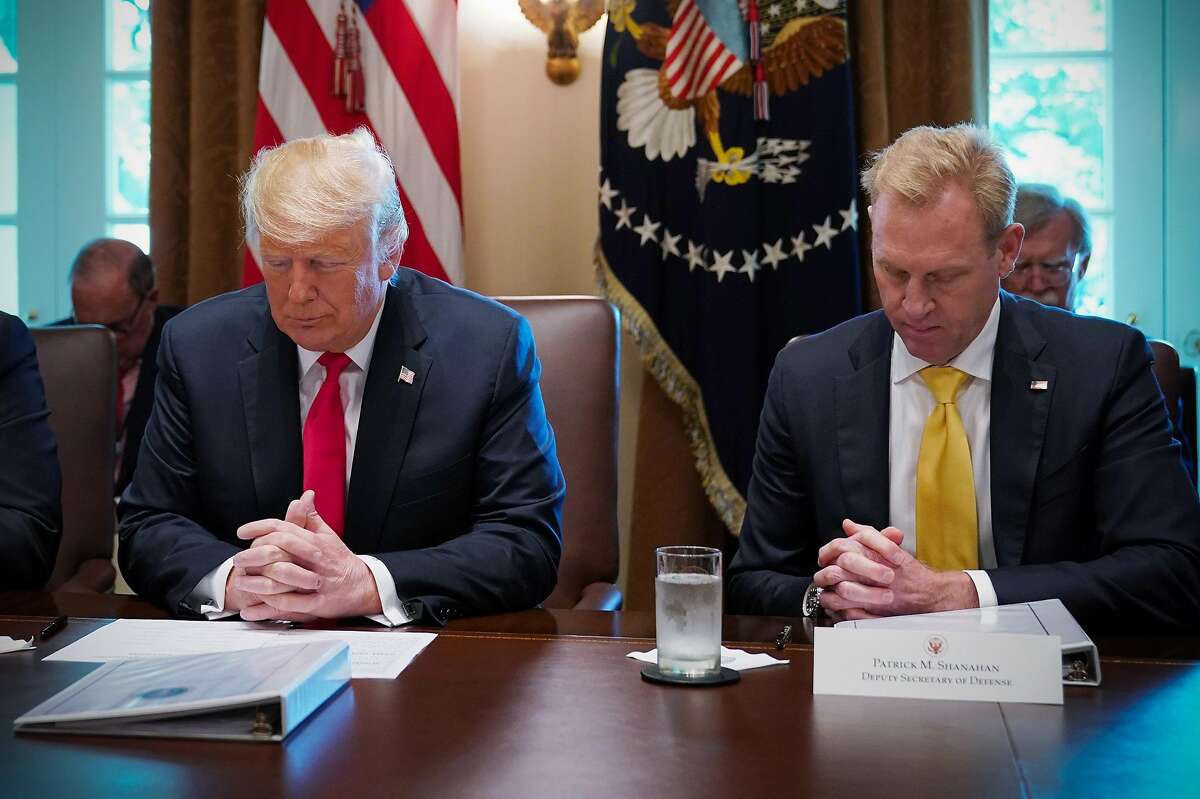 (FILES) In this picture dated August 16, 2018 in Washington, DC US President Donald Trump and Deputy Secretary of Defense Patrick Shanahan (R), bow their heads in prayer before the start of a Cabinet meeting in the Cabinet Room of the White House . - Donald Trump on December 23, 2018 announced he would replace Defense Secretary Jim Mattis with his deputy Patrick Shanahan, days after the outgoing Pentagon chief quit while citing key policy differences with the US president. "I am pleased to announce that our very talented Deputy Secretary of Defense, Patrick Shanahan, will assume the title of Acting Secretary of Defense starting January 1, 2019," the Republican leader tweeted, accelerating Mattis's planned departure by two months. (Photo by MANDEL NGAN / AFP)MANDEL NGAN/AFP/Getty Images