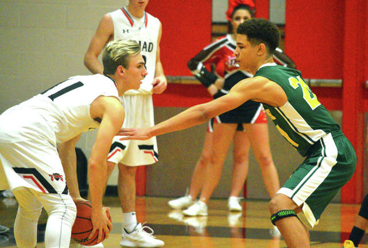 Metro-East Lutheran sophomore A.J. Smith, right defends Triad’s Joe Wade during a Dec. 17 game at Triad.
