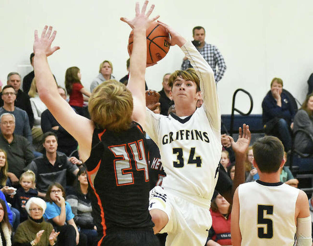 Father McGivney guard Clayton Scott goes up for a shot during a game against Marissa in Glen Carbon.