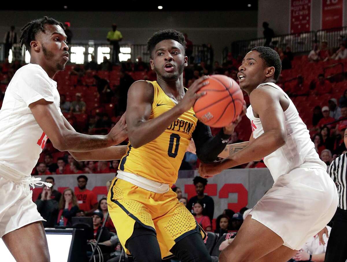 Coppin State guard Ibn Williams (0) looks to pass the ball between Houston guard Dejon Jarreau, left, and forward Brison Gresham, right, during the first half of an NCAA college basketball game Sunday, Dec. 23, 2018, in Houston. (AP Photo/Michael Wyke)