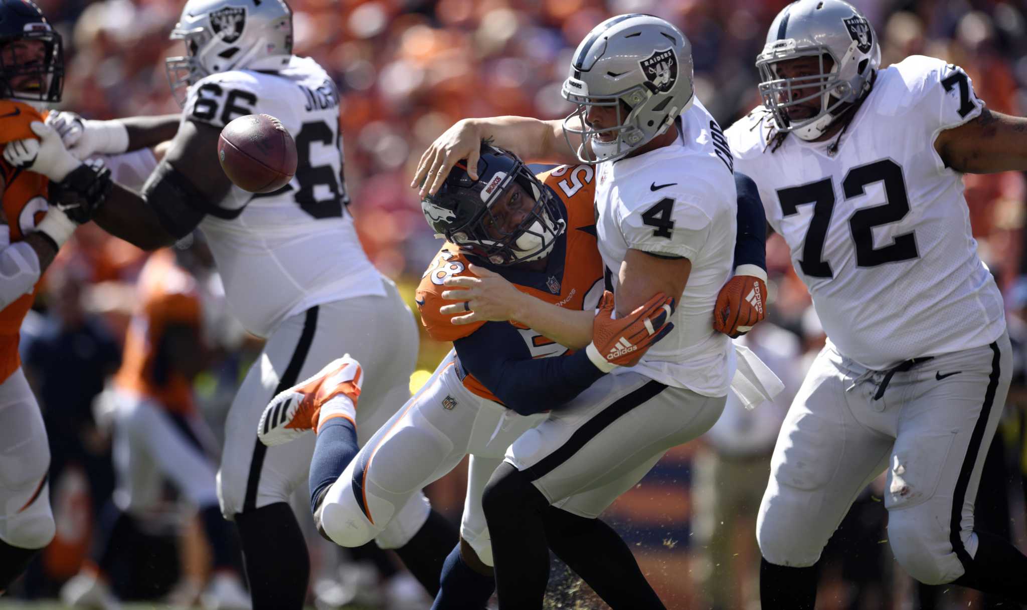 Raiders quarterback Derek Carr (4) is sacked by Cincinnati Bengals