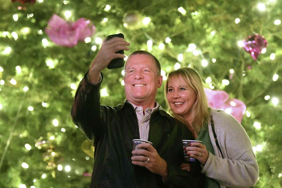Scott and Michele Bailey visit the Christmas tree in Alamo Plaza. The city’s official tree is in Travis Park, however.