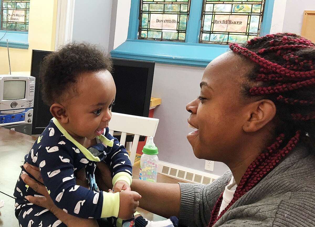 Zola Richardson, 27, plays with her son, 6-month-old Carl (CJ) Bussey III at Life Haven, where she is currently living with her three children.