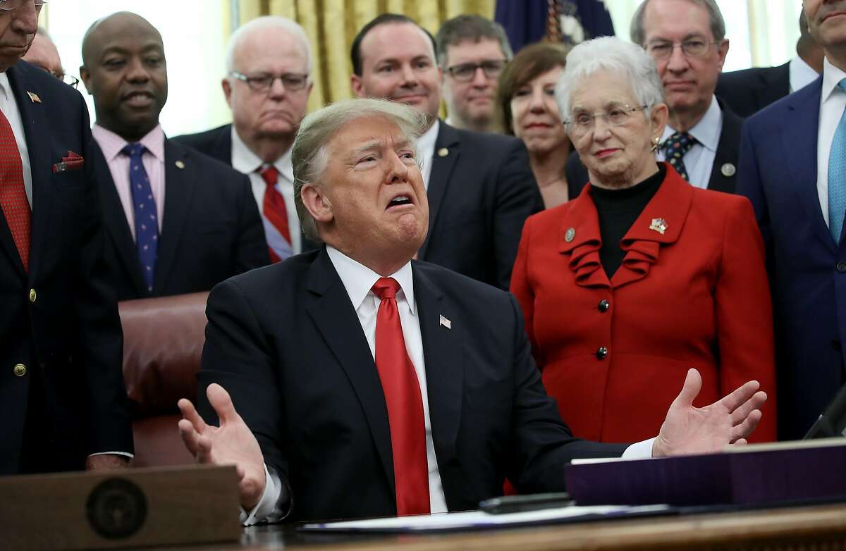 WASHINGTON, DC - DECEMBER 21: U.S. President Donald Trump speaks on the possibility of a government shutdown during the signing ceremony for the First Step Act and the Juvenile Justice Reform Act in the Oval Office of the White House December 21, 2018 in Washington, DC. The Trump administration is battling on multiple fronts with major developments on U.S. foreign policy in Syria, the resignation of Defense Secretary James Mattis, a falling stock market, and a potential governmental shutdown at midnight. (Photo by Win McNamee/Getty Images)