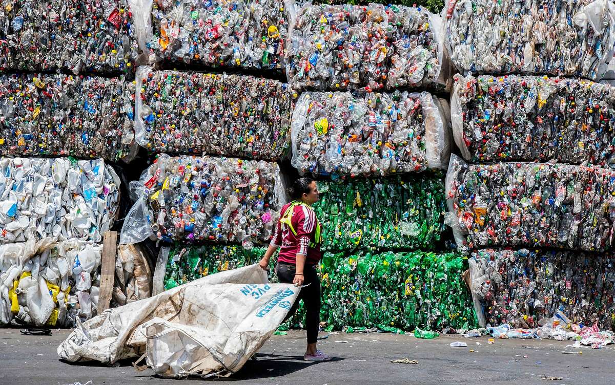 TOPSHOT - A worker walks in front of packed recyclable plastic bottles at La Sylvia recycling center in Barva, province of Heredia, Costa Rica on June 20, 2018. - Costa Rica discards 564 tons of plastic per day of which only 14 are recycled, according to the Ministry of Health's Office of Environmental Health in charge of waste management in the country. Since April 2018, a program seeks to stimulate recycling by giving value to waste through the exchange of it for a virtual currency that allows users to make purchases at stores linked with the initiative. (Photo by EZEQUIEL BECERRA / AFP)EZEQUIEL BECERRA/AFP/Getty Images