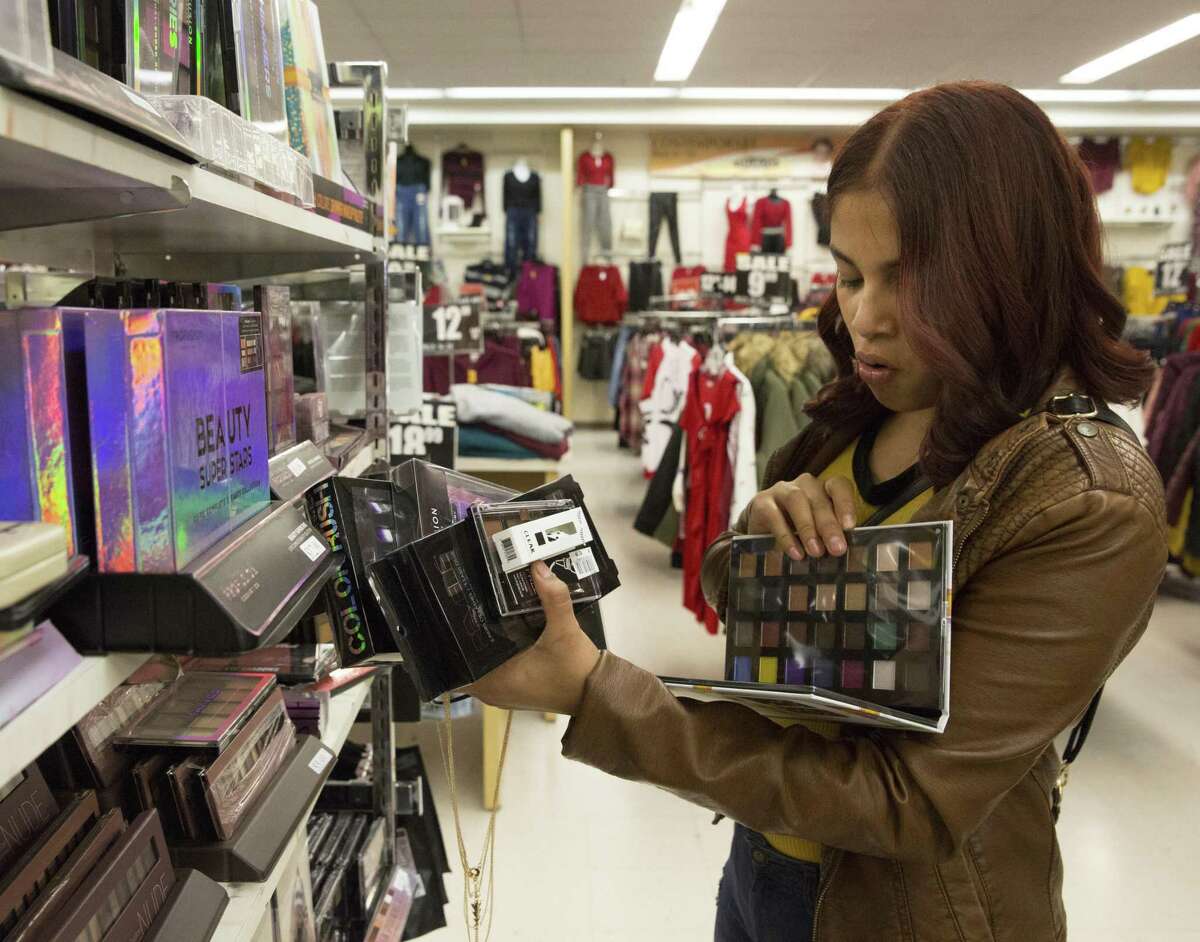 Elsy Zelaya goes through the makeup sets at Melrose Family Fashions for her Christmas shopping at PlazAmericas on Thursday, Dec. 20, 2018, in Houston. Baker Katz, a Houston-based full-service commercial real estate firm, has purchased PlazAmericas Mall, an 850,000-square-foot enclosed center.