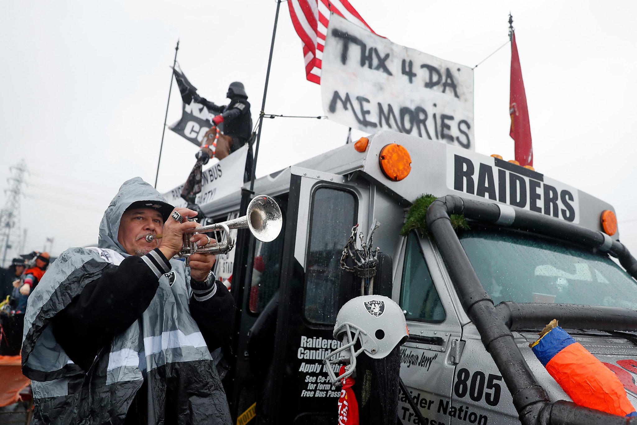 Oakland Raider fans pose during tailgating festivities before game