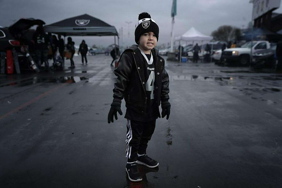 Oakland Raiders fans don matching holiday outfits during the first