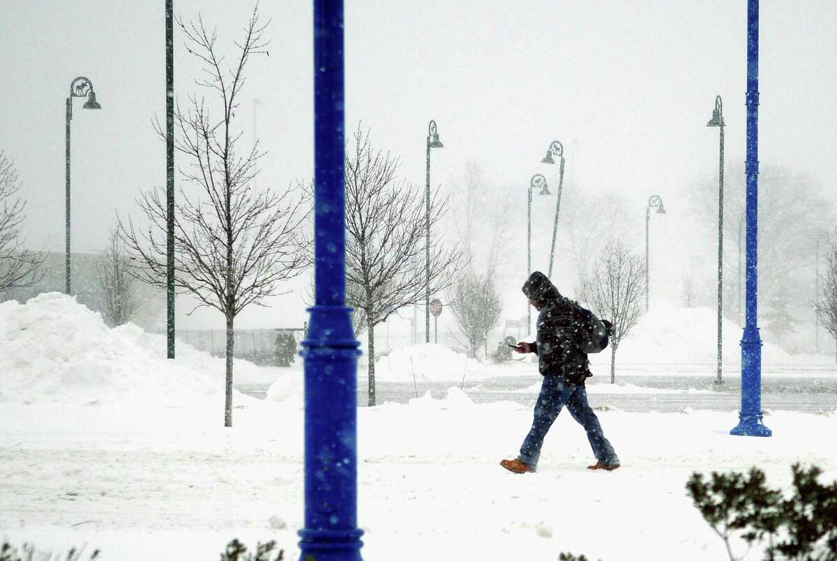 During a nor-easter that is pounding the region, a pedestrian walks along East Main Street in the Steel Point area in Bridgeport, Conn., on Thursday Jan. 4, 2018.