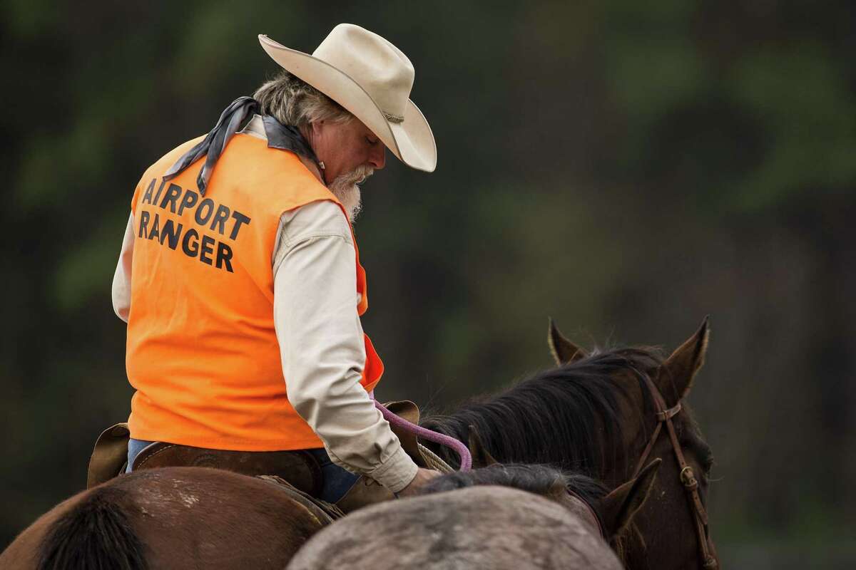 Kelly Baber prepares to ride along the perimeter fence at George Bush Intercontinental Airport on Monday, Dec. 17, 2018, in Houston. The Airport Rangers are mounted patrols that include off-duty law enforcement officers who ride their horses along the perimeter of the 13,000 acres of IAH including wooded trails.