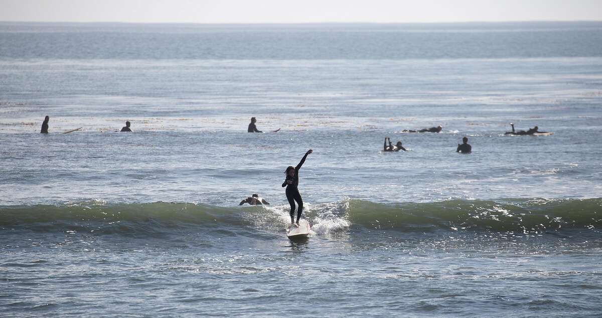 Student Miguel Pastreich, 17, catches a wave at Private's Beach as City Surf Project takes a group of Mission High School students surfing on Friday, Dec. 21, 2018, in Santa Cruz, Calif.