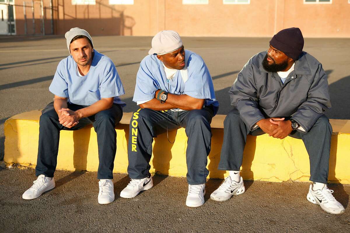 San Quentin inmates Adnan Khan, left, Shadeed Wallace-Stepter, center and Earlonne Woods are seen on the yard on June 27, 2018. Wallace Stepter and Woods have since been released from prison and are going through the Re:store Justice re-entry program in Oakland, Calif.