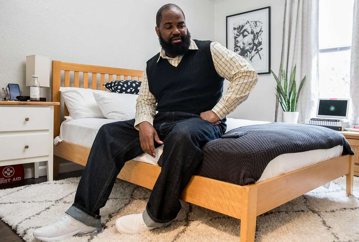 Earlonne Woods, whose sentence was recently commuted allowing his release from San Quentin, sits inside his new room at Re:Store Justice in Oakland, Calif. Thursday, Dec. 20, 2018.