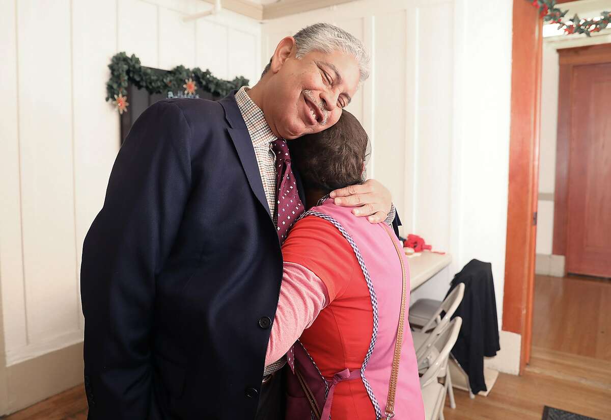Executive director Sam Ruiz (left) gets a hug from volunteer Silvia Lopez (right), who has been working at the Mission Neighborhood Center on Thursday, Nov. 29, 2018, in San Francisco, Calif.