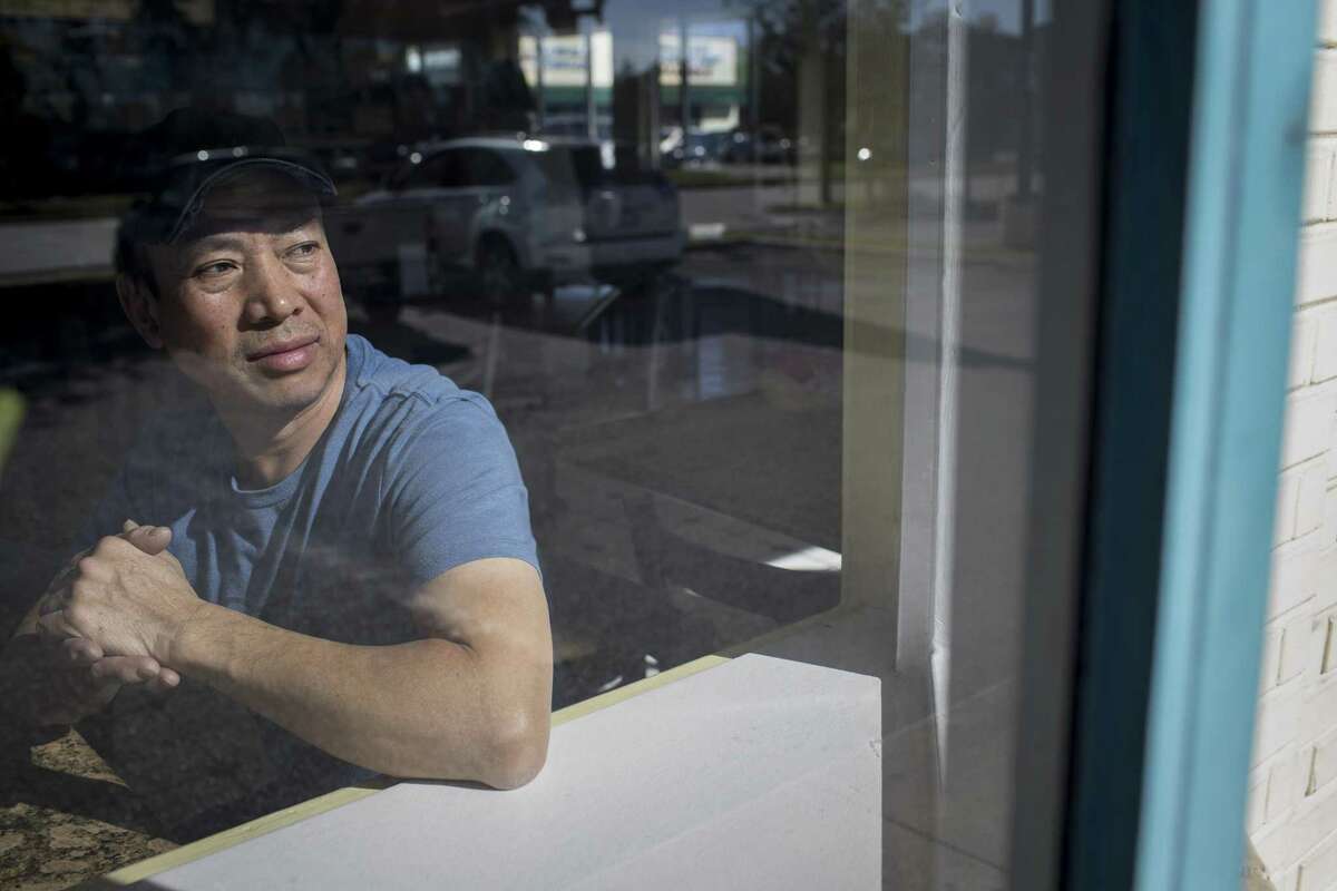 Kevin Khong, who own's Don's Cafe and Sandwiches in the Chinatown area, said some of his customers have been reluctant to contact police after robberies. Khong looks out onto his parking lot, Tuesday, Dec. 4, 2018, in Houston.