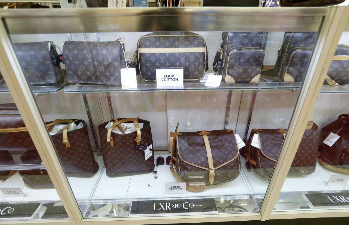 LXR and Co. purses on display that include Louis Vuitton, Kate Spade, Coach, Ferragamo, and Balenciaga at the ThredUp pop-up shop inside of the Palais Royal store in Meyerland, Wednesday, Nov. 21, 2018, in Houston. The store-within-the-store offers second-hand clothing that appeals to shoppers who like to thrift shop.