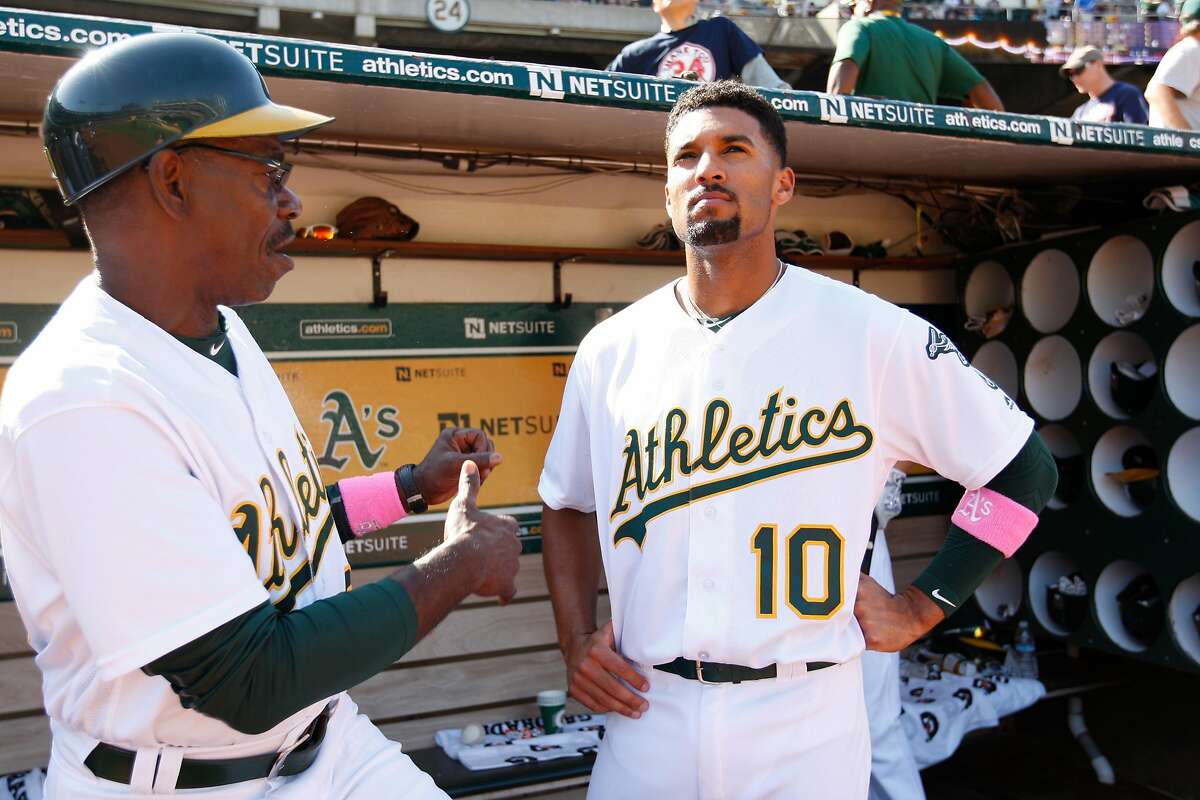 OAKLAND, CA - SEPTEMBER 4: Third Base Coach Ron Washington #38 and Marcus Semien #10 of the Oakland Athletics talk in the dugout during the game against the Boston Red Sox at the Oakland Coliseum on September 4, 2016 in Oakland, California. The Athletics defeated the Red Sox 1-0. (Photo by Michael Zagaris/Oakland Athletics/Getty Images)