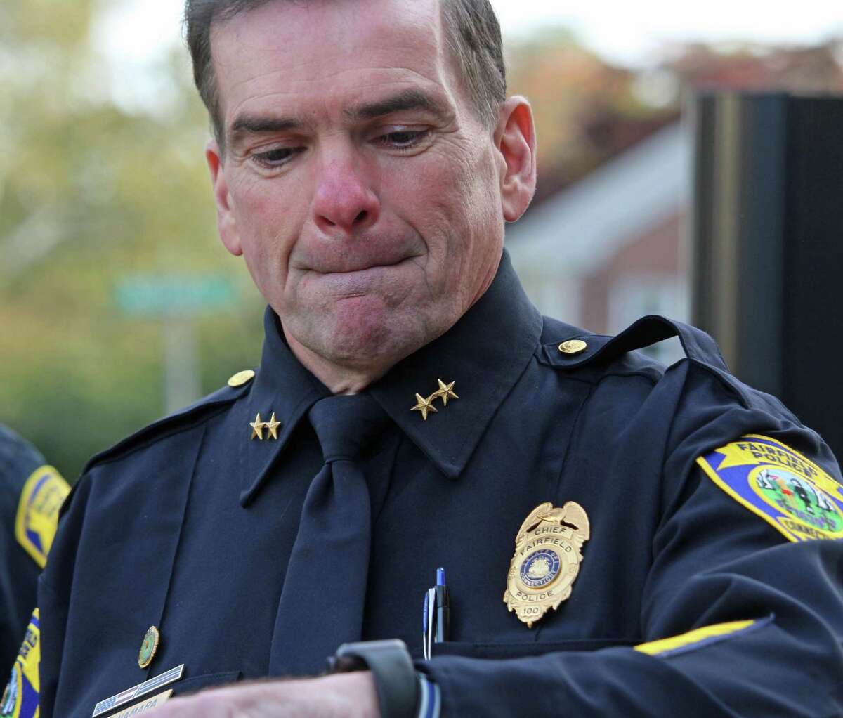 Outgoing Police Chief Gary MacNamara checks his watch as his last day on the job winds down on Oct. 26.