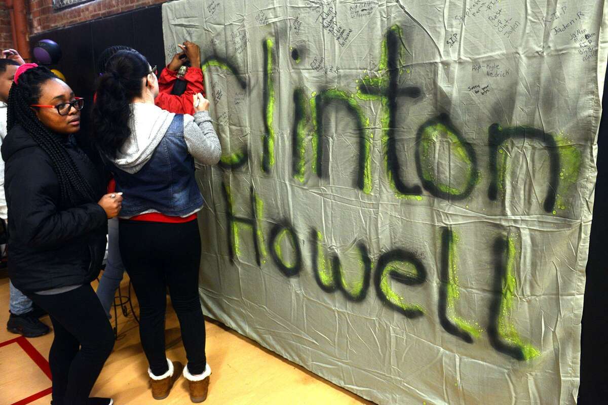 Students sign a banner in honor of Clinton Howell prior to a Celebration of Life service held at The Bridge Academy, in Bridgeport, Conn. Dec. 21, 2018. Howell, 12, a 7th grader at the school, was killed by gunfire outside his home Tuesday evening.
