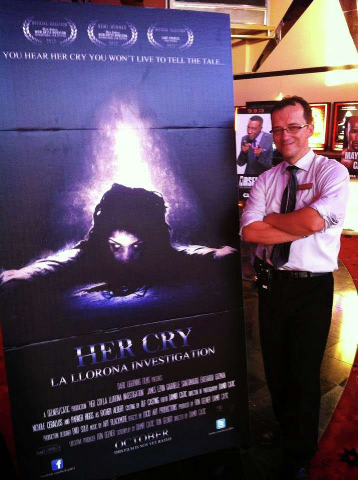 Damir Catic next to the poster for his film, 'Her Cry.'
