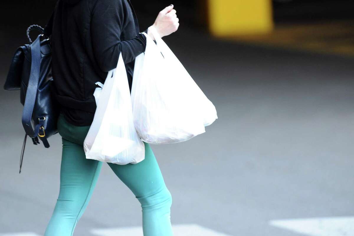 Customers exit Stop & Shop with plastic bags inside the Ridgeway Shopping Center between Summer St. and Bedford St. in Stamford, Conn. on Monday, March 26, 2018. Stamford lawmakers are attempting to ban single-use plastic bags.