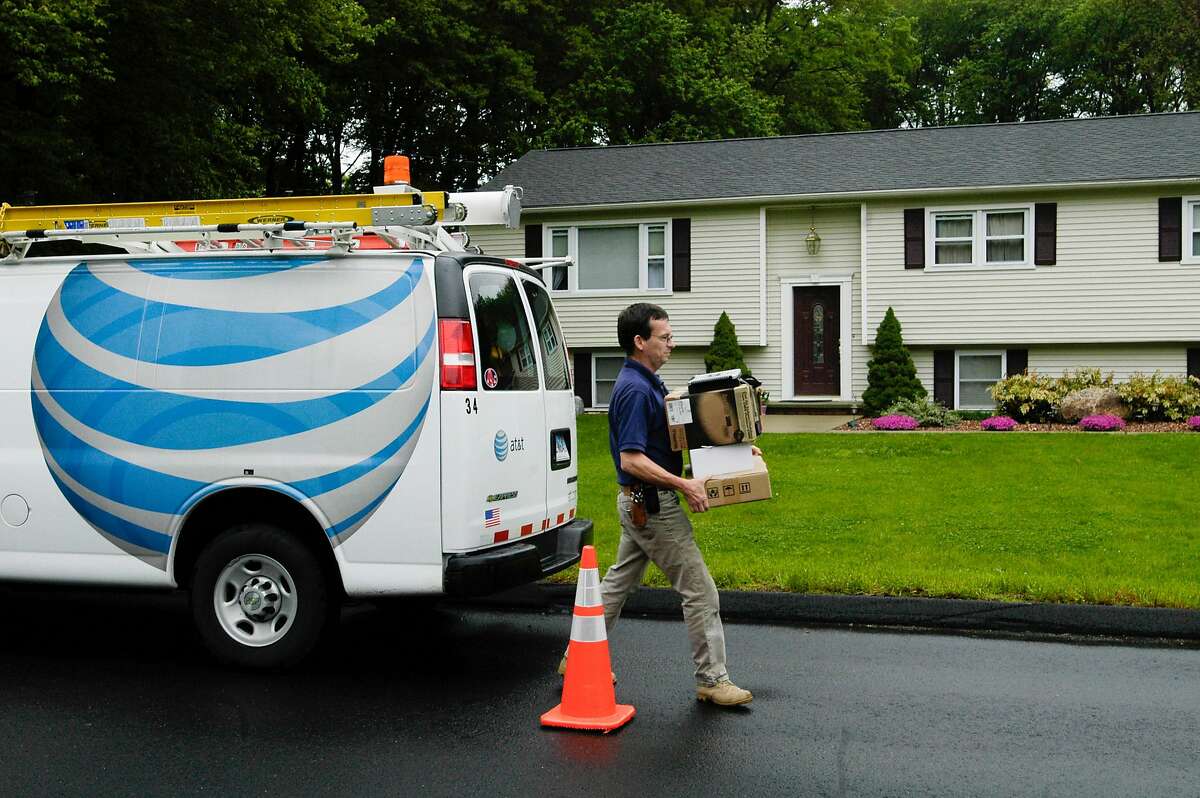 FILE -- An AT&T technician at work in Shelton, Conn., June 6, 2008. After the tax law was passed, the company handed out worker bonuses and contributed to its employee and retiree medical trust fund, but it also appears to be shedding employees. (Brandon Thibodeaux/The New York Times)