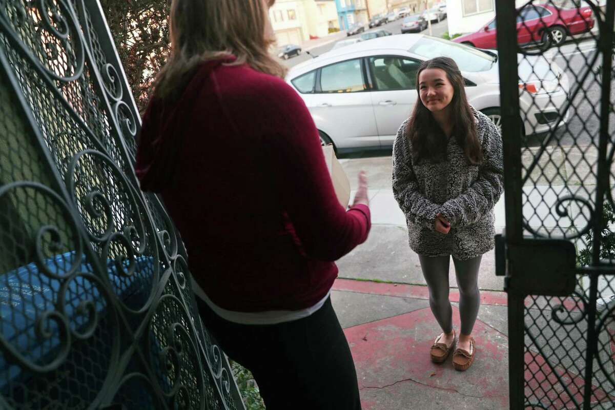 Emily Pierceall (left) thanks Maddie Johnson for returning a stolen package addressed to her roommate that Maddie found in a parking lot.