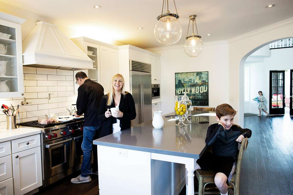 Ramin Ramhormozi, Jenny Romeyn and their son Own 9, and daughter Avery 5, in their home in Santa Rosa, California, December 26th, 2018. Jenny Romeyn and her husband Ramin Ramhormozi sold their large home on Skyhawk because they think when all the Fountaingrove homes are rebuilt and on the market, it will be hard to sell a large home in Santa Rosa. They bought a smaller home in need of work near downtown, which is close to both their jobs and their kids' school. They are remodeling the new house and renting back the old house till the end of January.