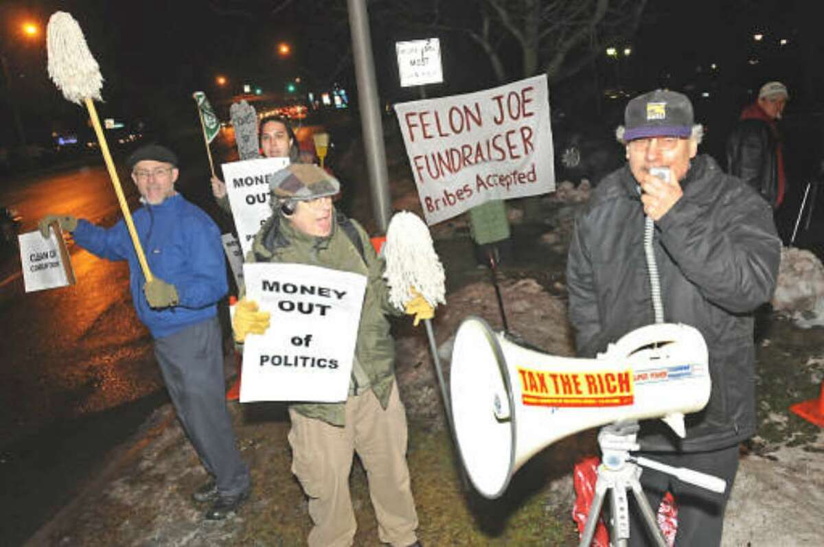 A protest against corrupt government is held Tuesday outside a Colonie fundraiser for formerstate Sen. Majority Leader Joseph L. Bruno. He awaitings sentencing after being convicted of two federal corruption charges. ( LORI VAN BUREN/TIMES UNION)