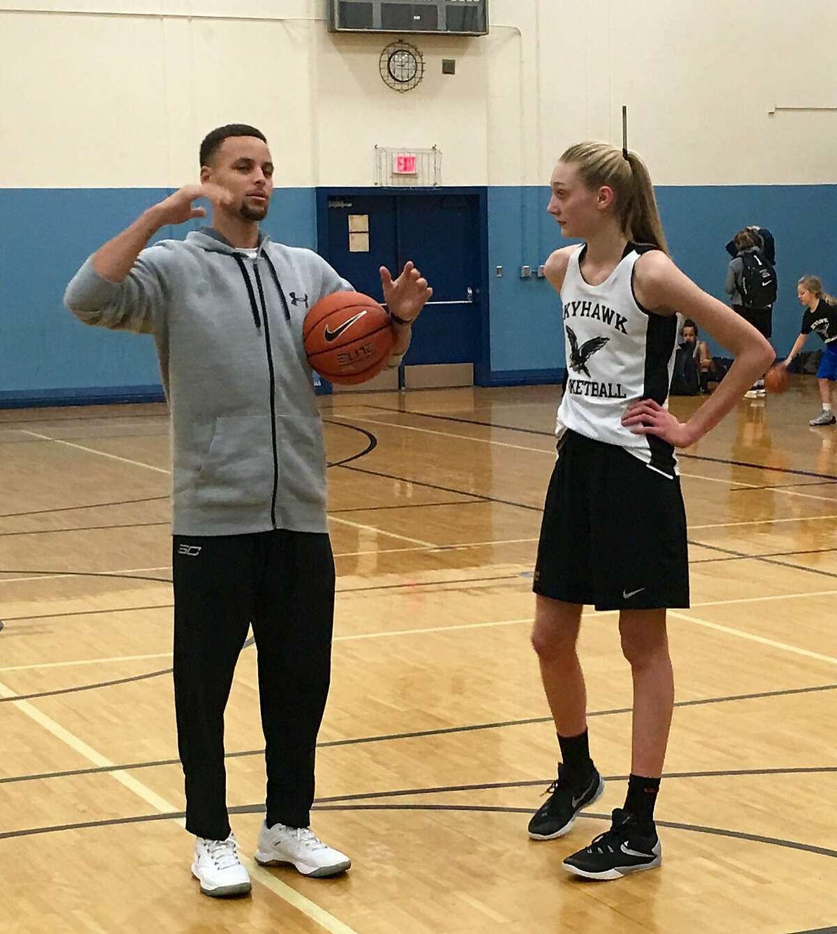 Stephen Curry offers pointers to Cameron Brink during a 2013 workout.