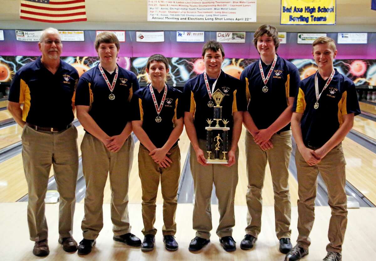 The Bad Axe bowling team poses with its conference trophy, after winning 316-315 championship match over Harbor Beach. The Hatchets needed three straight strikes to win the match, and Gavynn Guigar delivered.