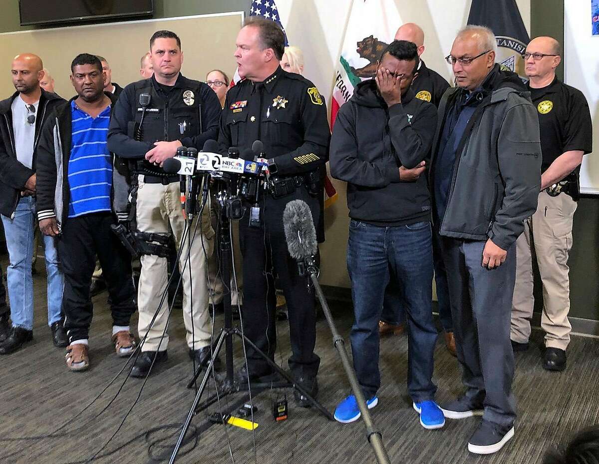 Law enforcement and family members of slain Newman Police officer Ronil Singh listen to Stanislaus County Sheriff Adam Christianson, center, talk about the arrest of suspect Gustavo Perez Arriaga and others during a press conference at the Stanislaus County Sheriff's Department Friday, Dec. 28, 2018, in Modesto, Calif. Perez Arriaga is accused of killing Cpl. Singh of the tiny Newman Police Department on Wednesday after being stopped on suspicion of drunken driving.