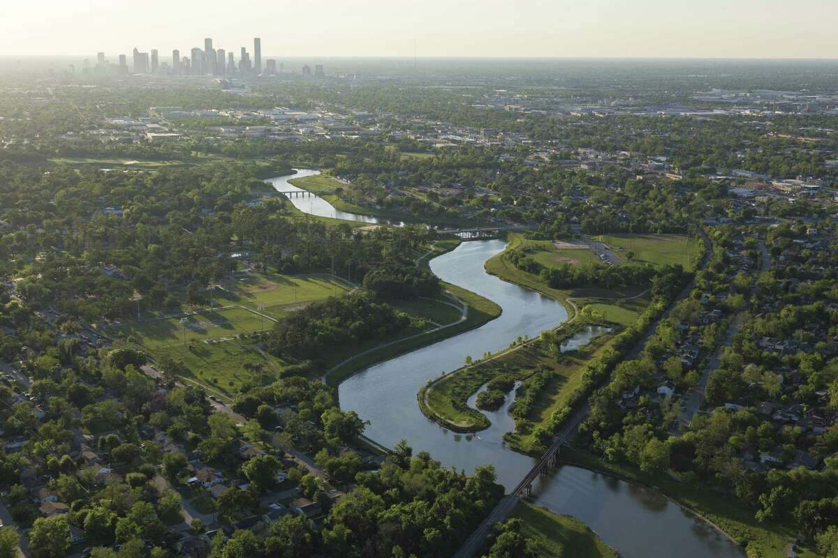 Houston skyline is seen with the Brays Bayou greenway in the forground.